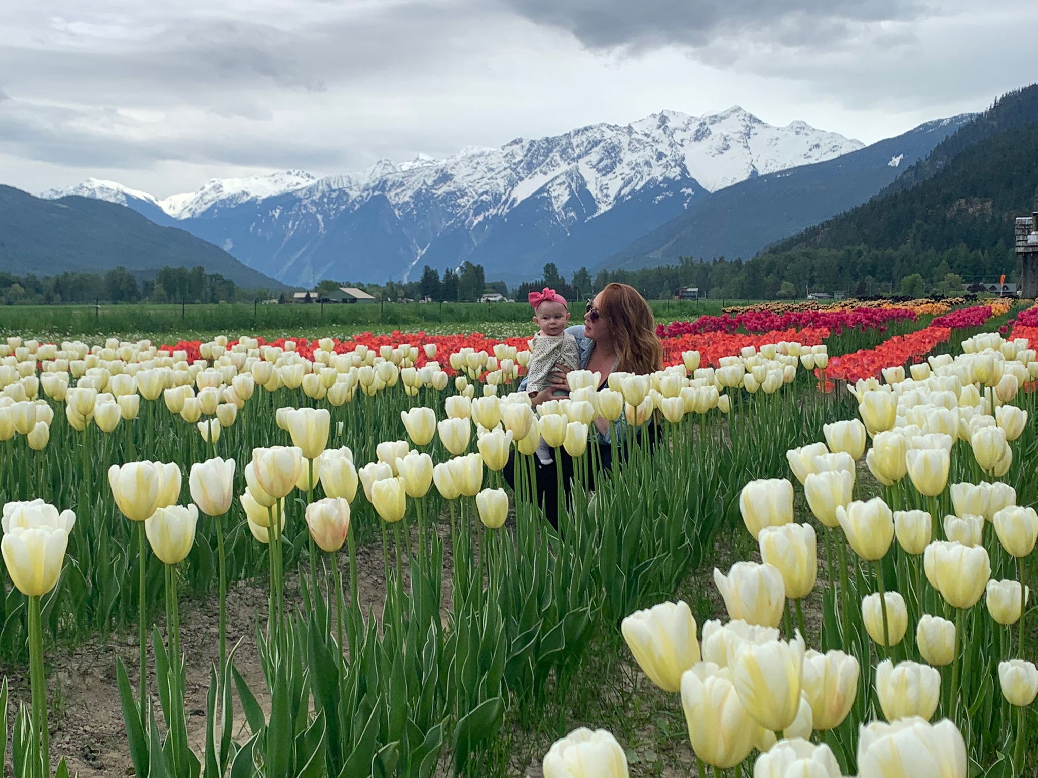 Kristi and her daughter in a field of tulips